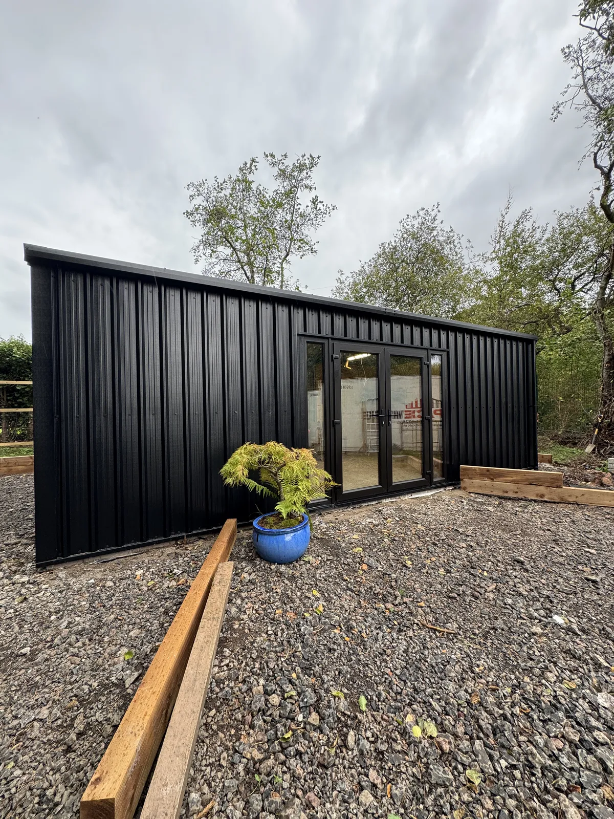 Black steel shed with glazed French doors
